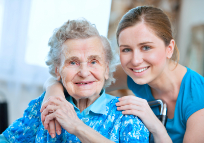 Senior woman with her caregiver at home